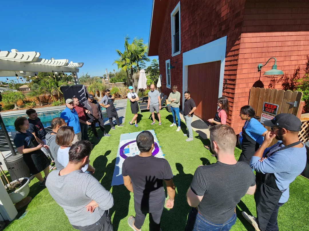 Photo of the Invisible AI staff standing in a circle around artwork on the ground