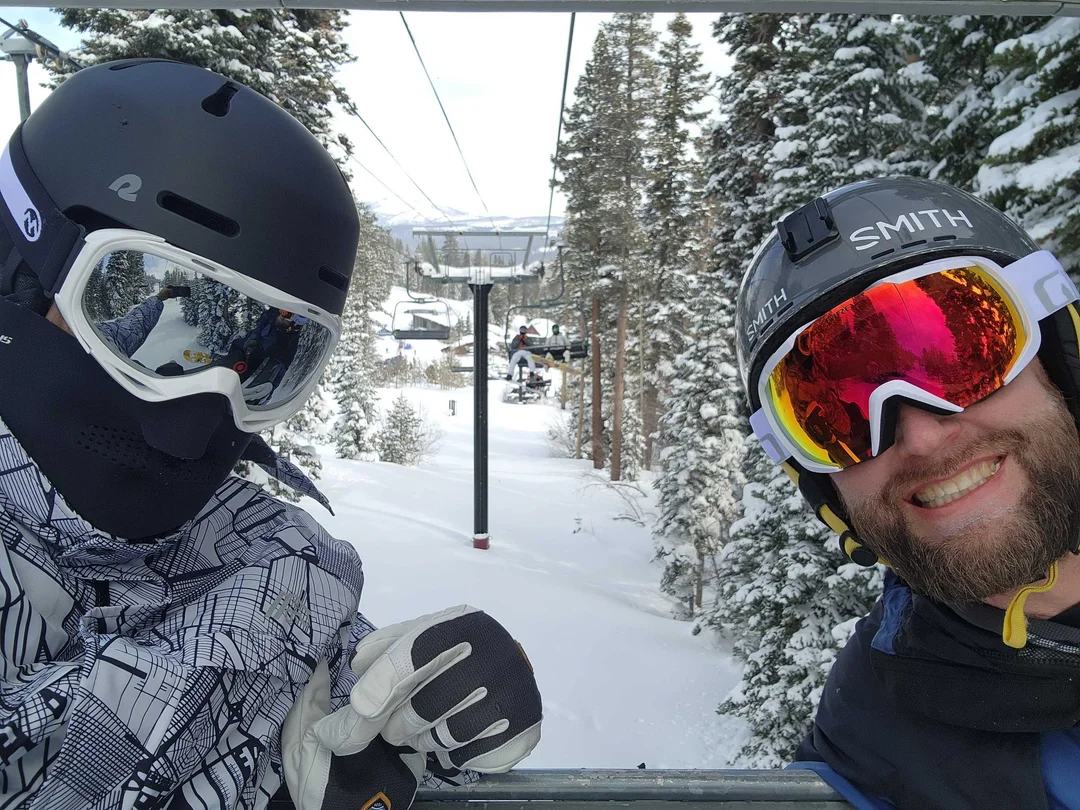 Photo of two members of Invisible AI staff on a ski lift