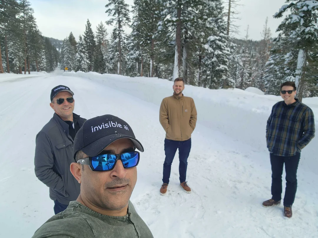 Photo of 4 members of Invisible AI staff standing outside in the snow